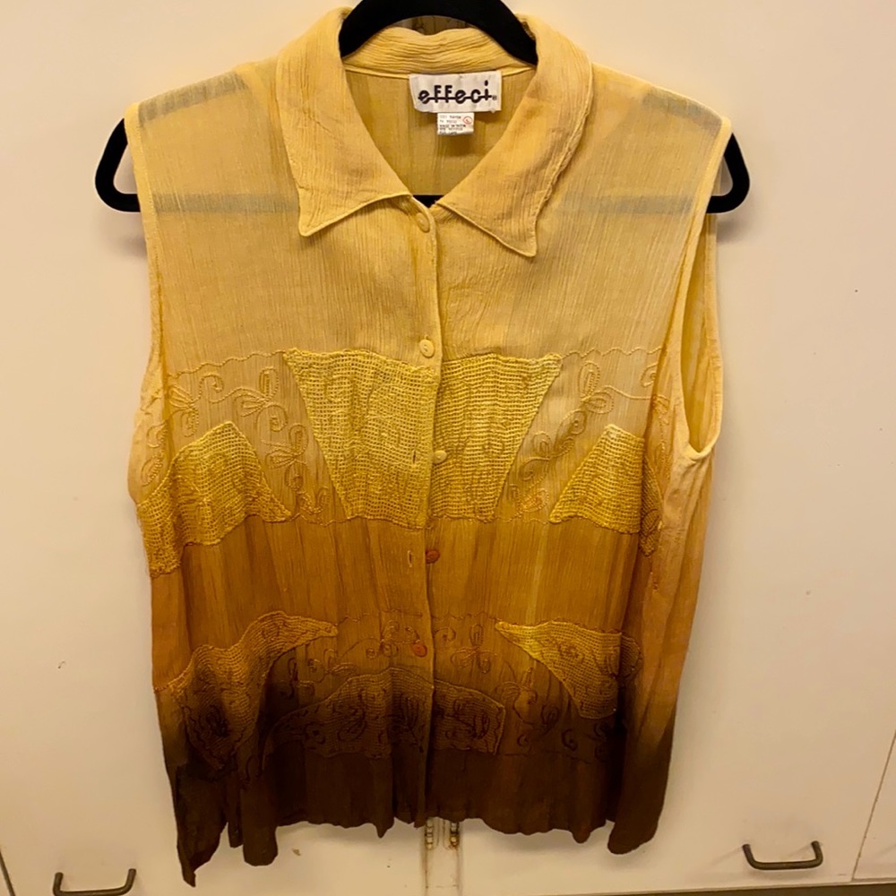 Sleeveless multi-coloured shirt.